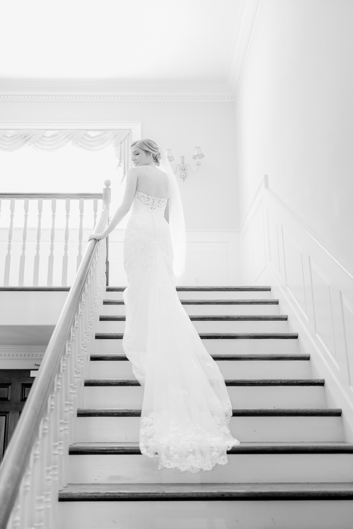 bride walking up stairs at Stone Manor Country Club
