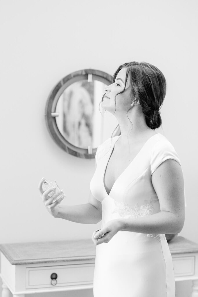 a bride putting on perfume
