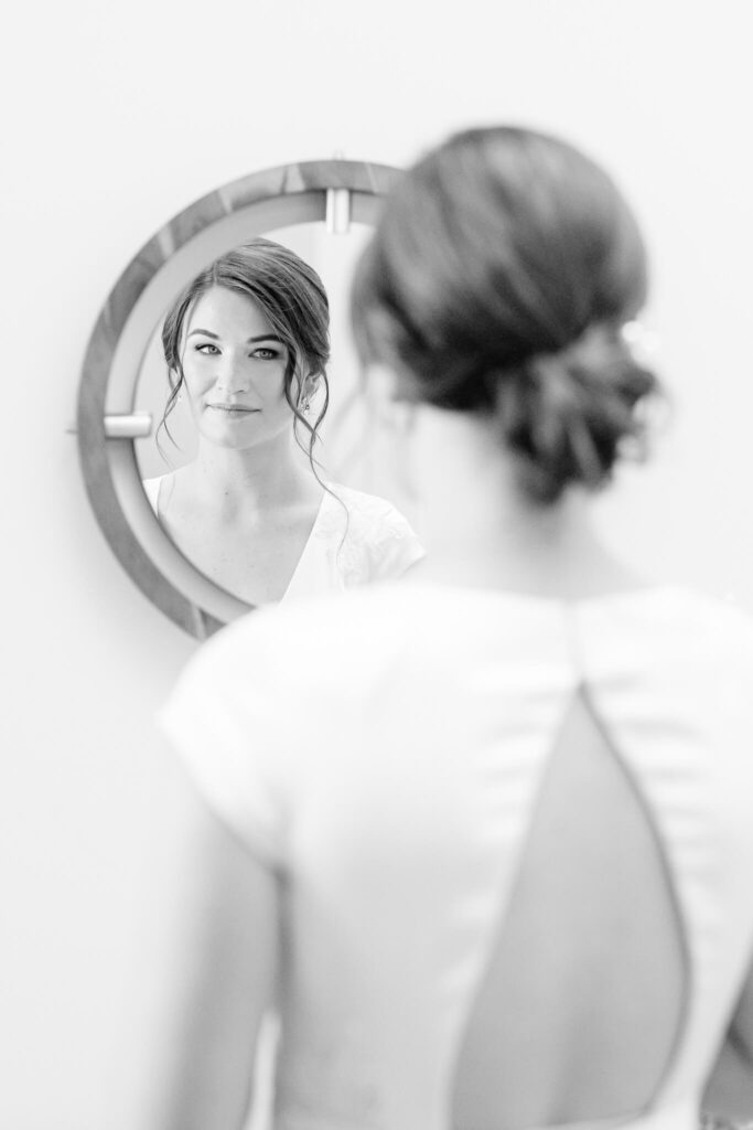 a bride looking in the mirror before her Old Town Alexandria Wedding