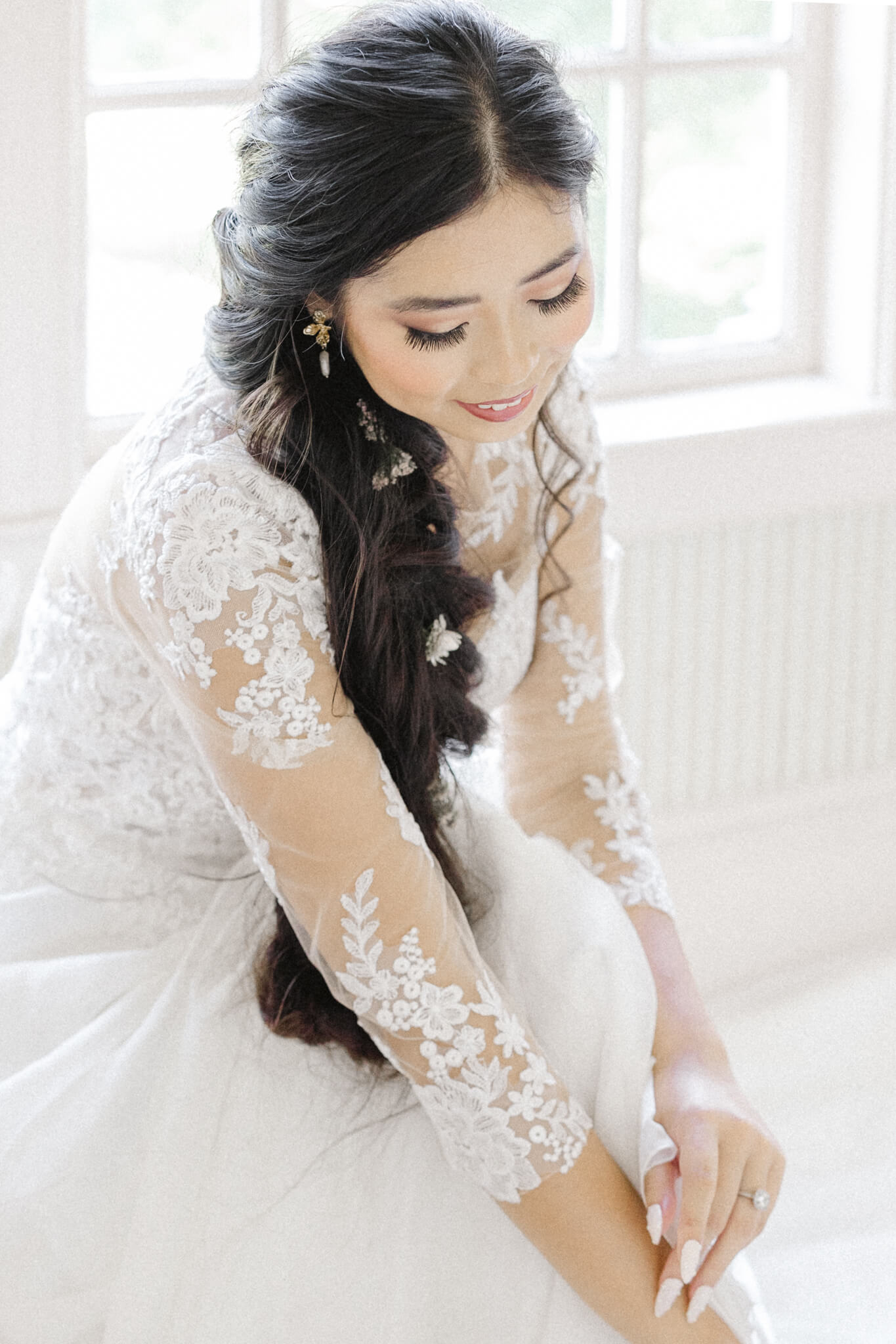 fine art photograph of bride in lace gown leaning forward