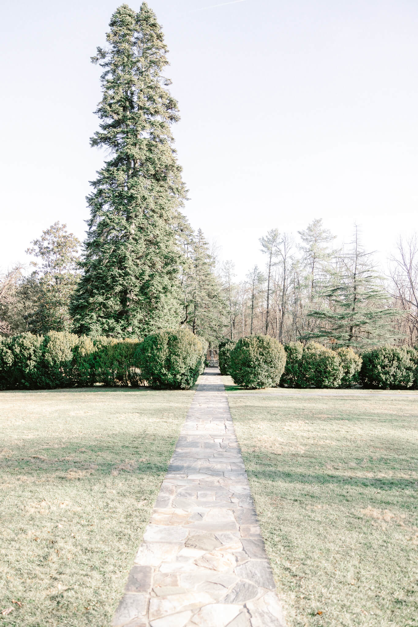 View of the stone path and gardens of Rust Manor House wedding venue