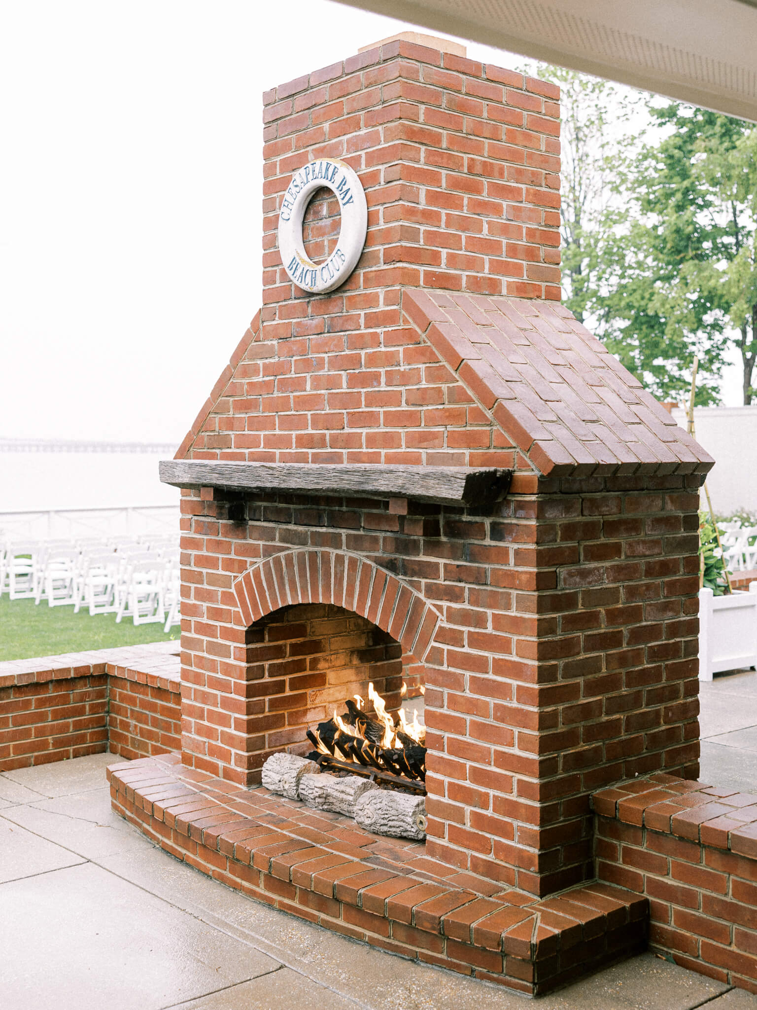A fire in outdoor fireplace by the outdoor reception area of Chesapeake Bay Beach Club