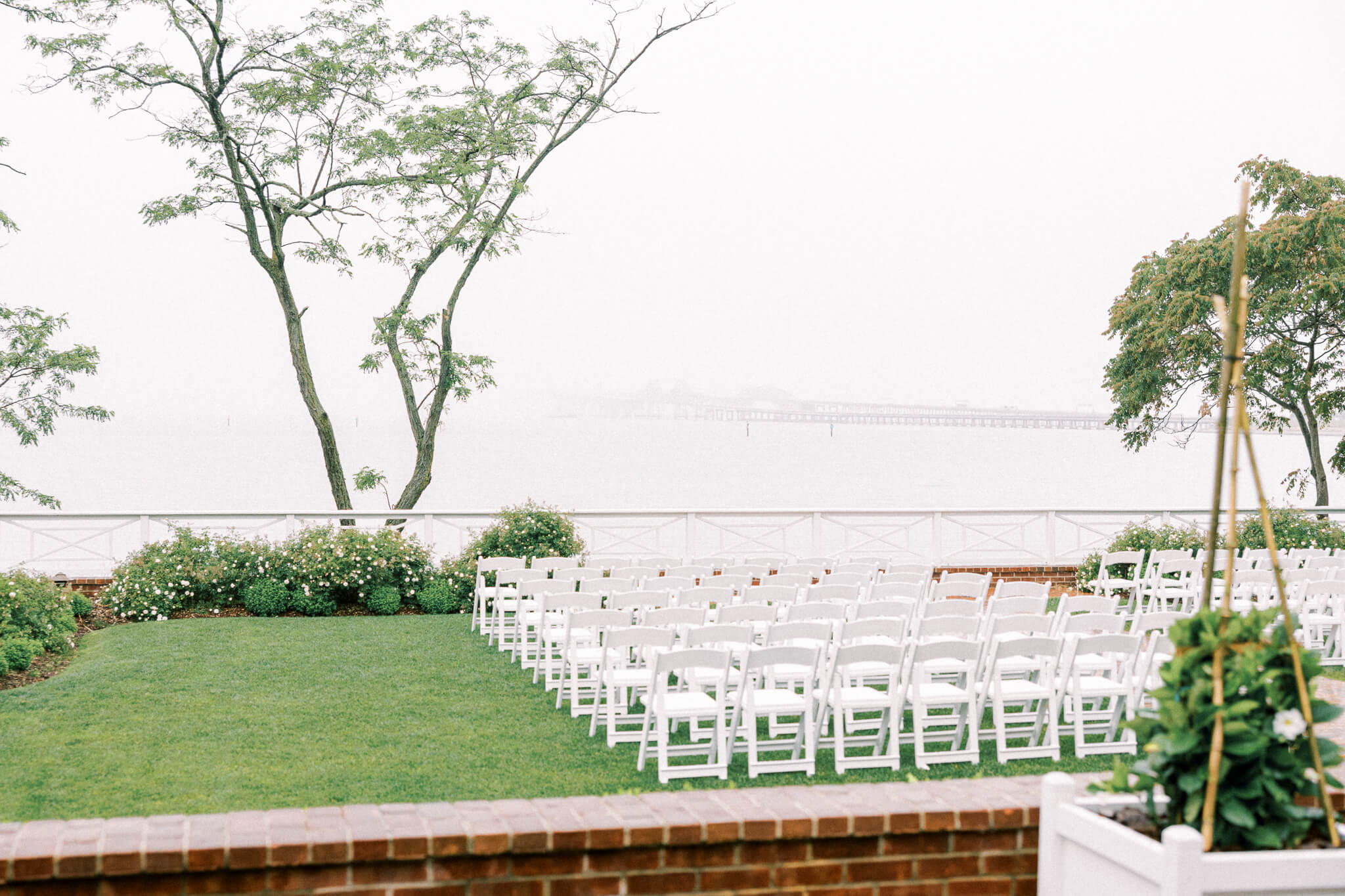 The outdoor reception space with white folding chairs overlooking the Chesapeake Bay 