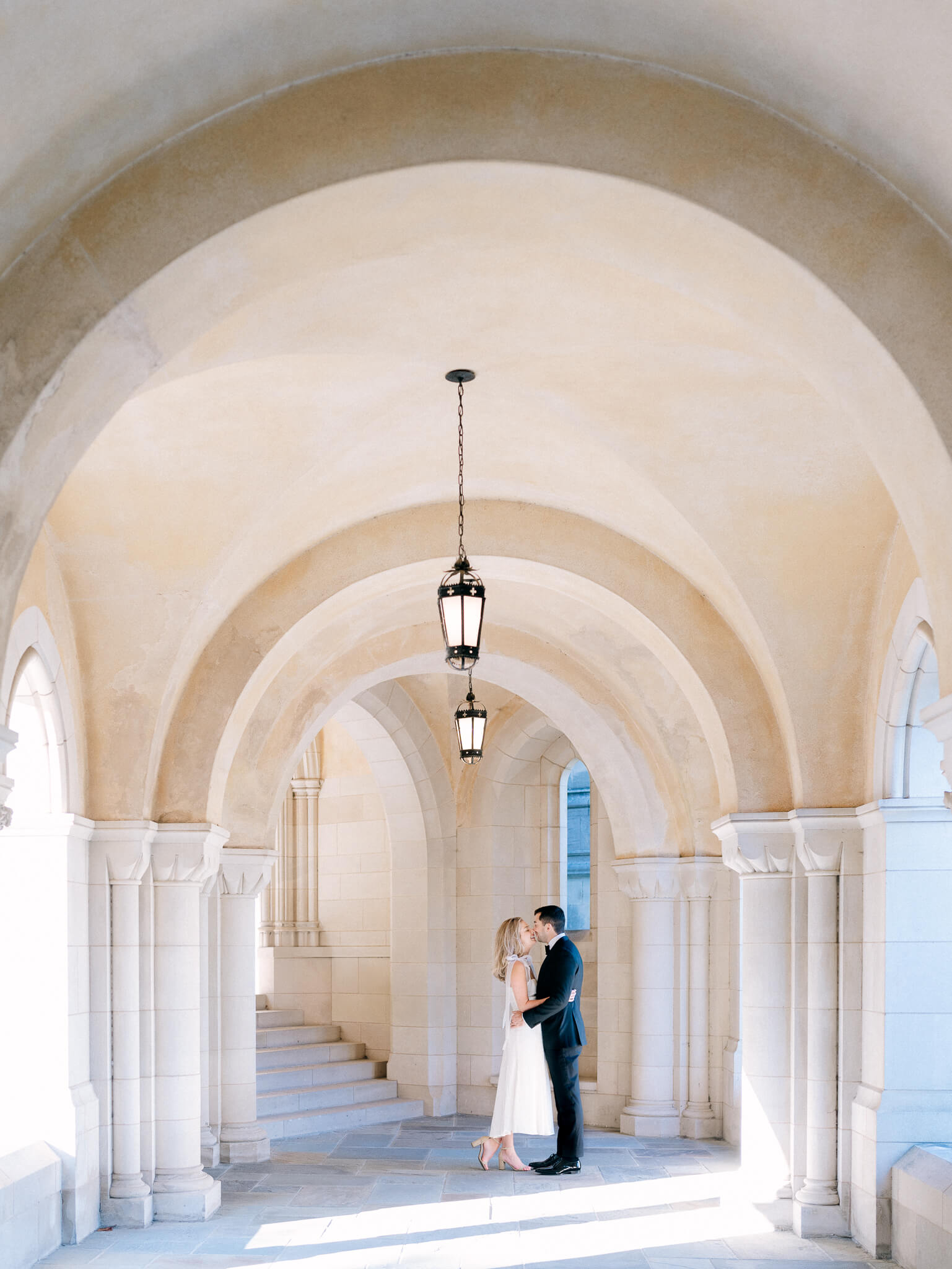 A couple embracing in the arches of the National Cathedral in Washington, D.C.