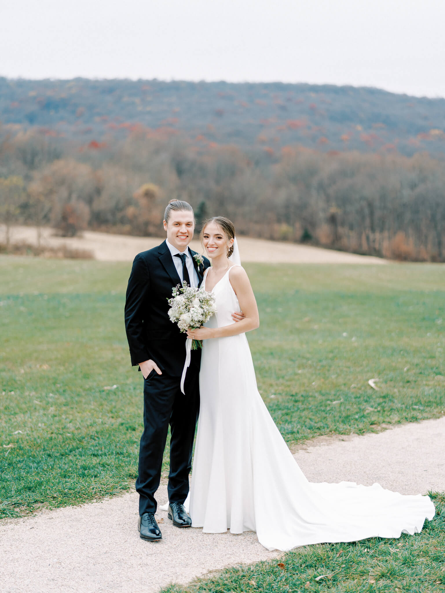 Formal wedding portrait of the newlywed bride and groom in front of the mountainous backdrop at Springfield Manor.