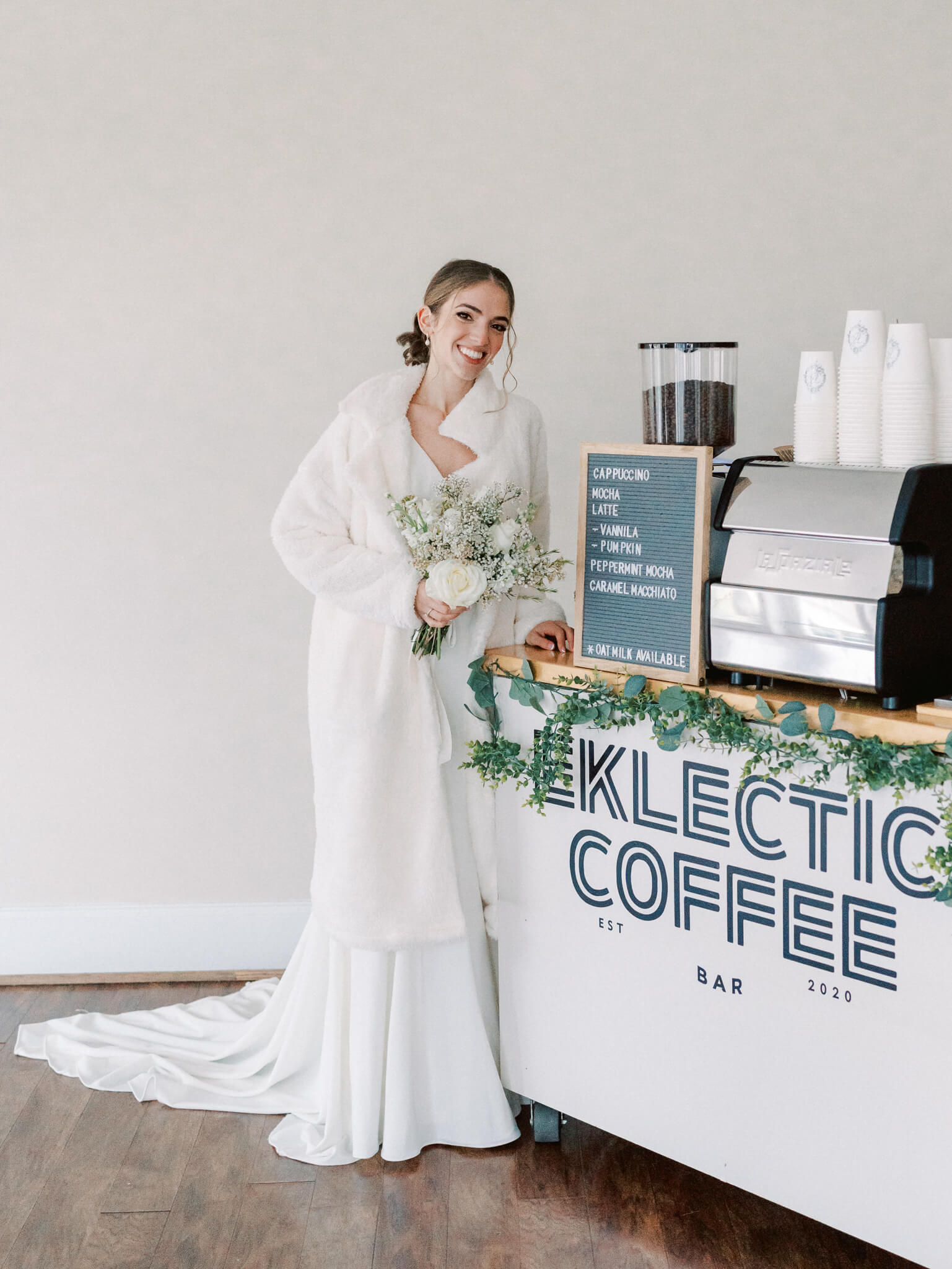 A bride standing next to her coffee bar cart.