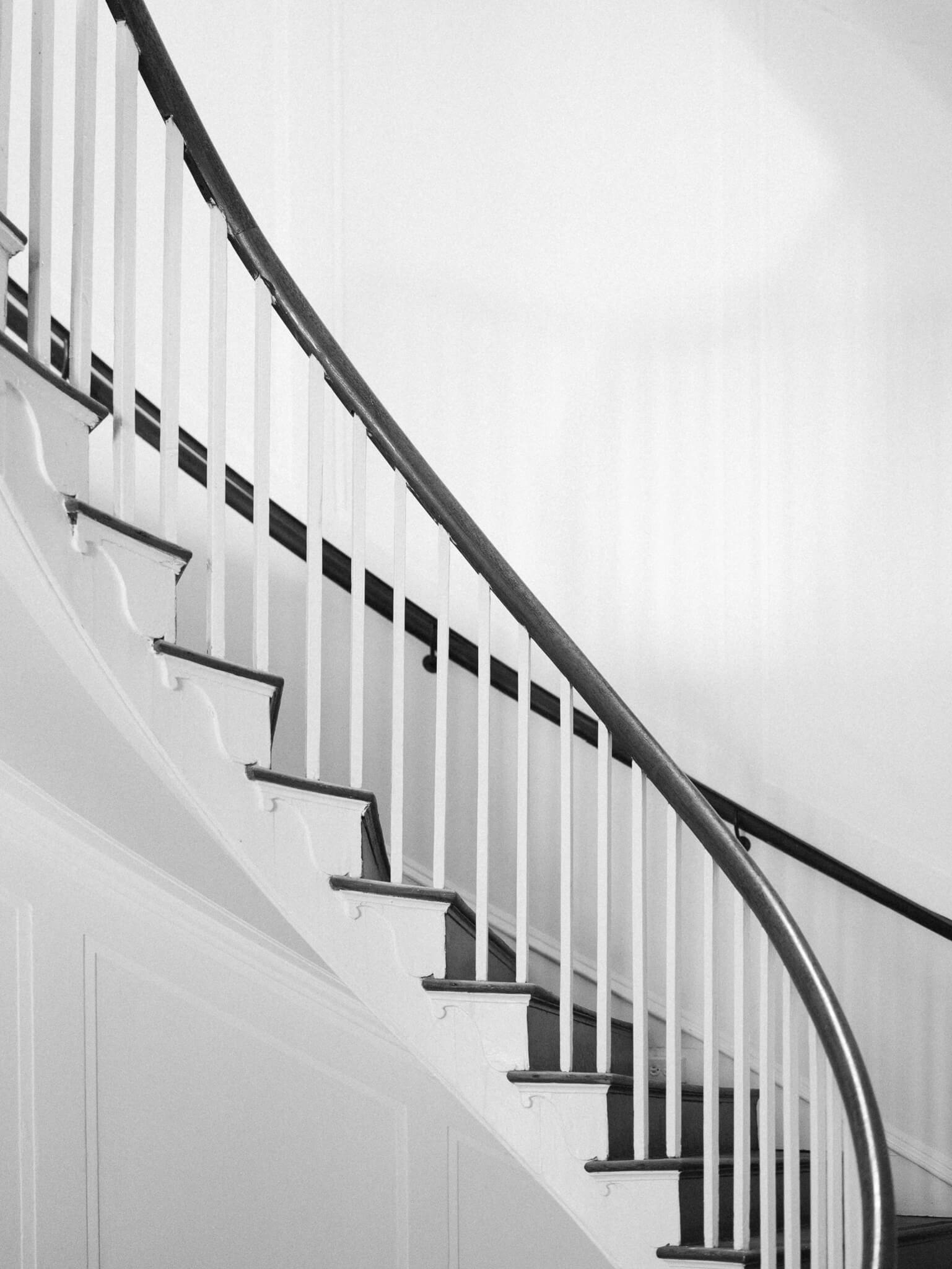 Black and white image of spiral staircase at Lowndes Grove Wedding Venue in Charleston, South Carolina.