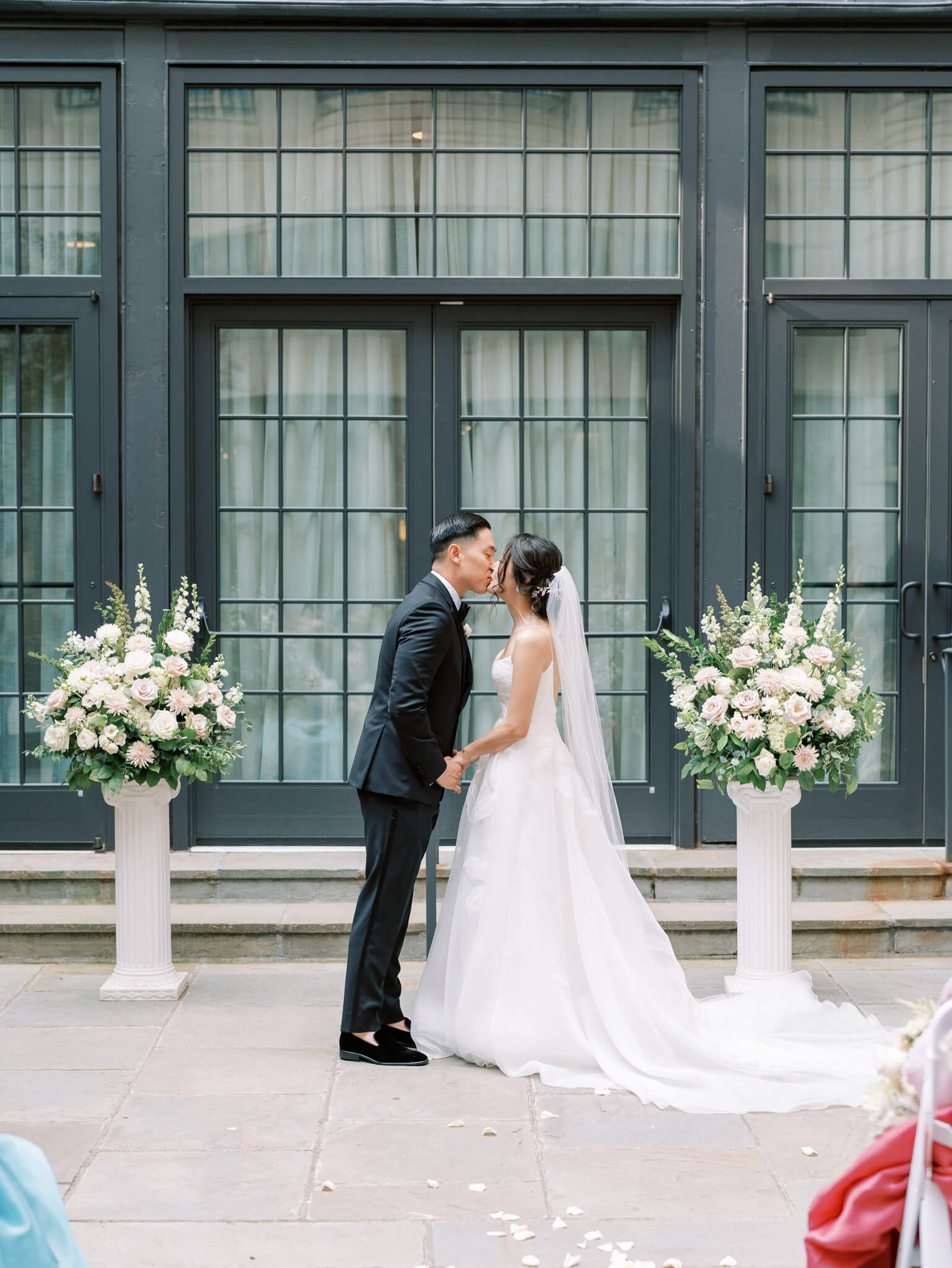 A bride and groom's first kiss at their Westin Georgetown Wedding in the courtyard.