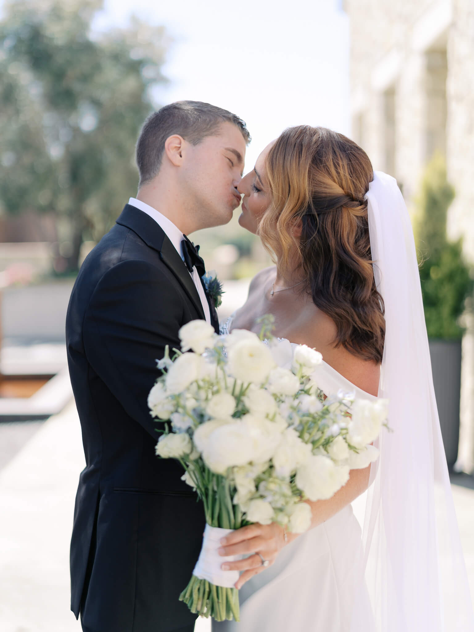 A bride and groom leaning in close and almost kidding at their destination wedding weekend.