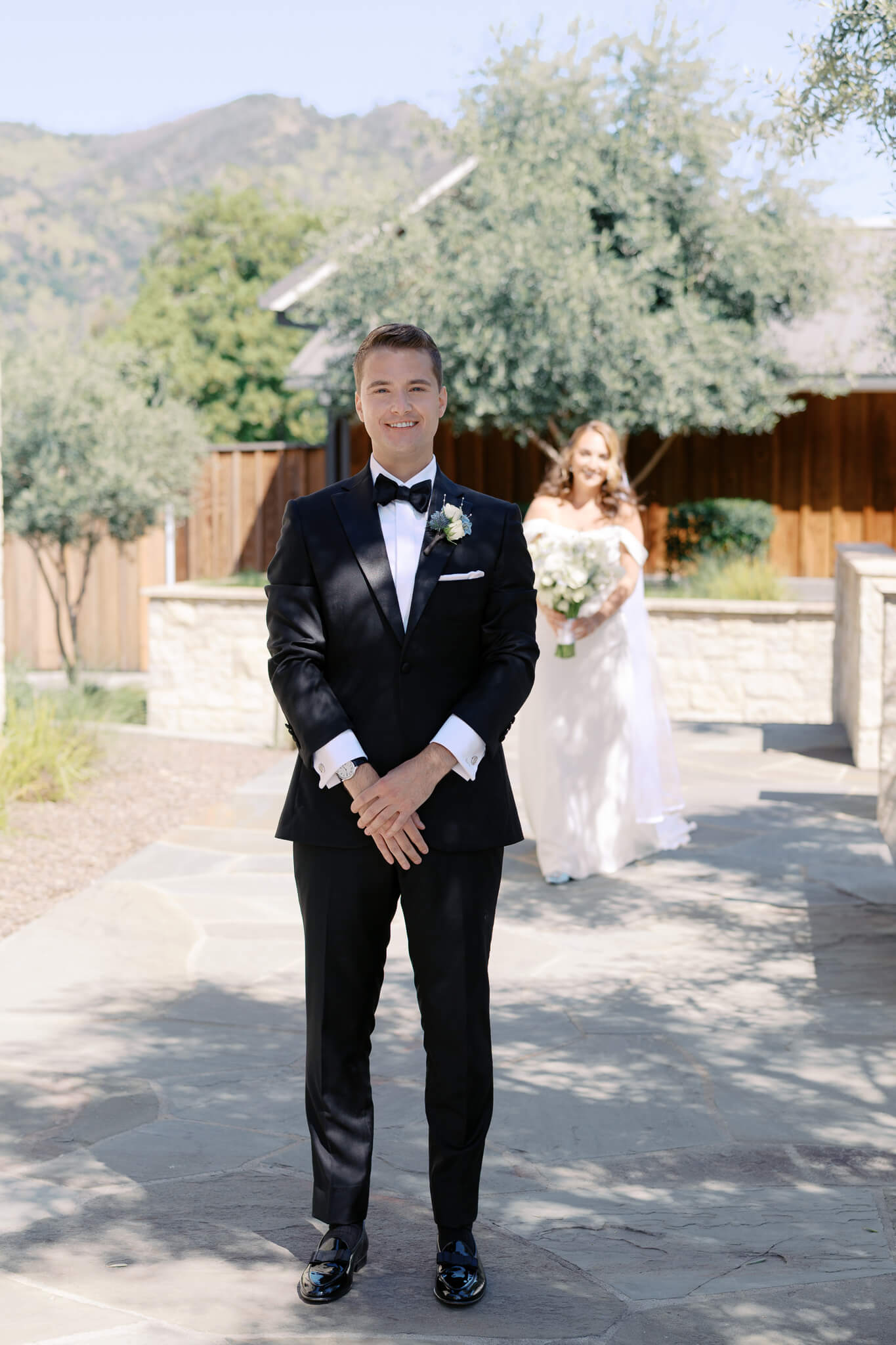 A bride walking up behind her groom for a first look during their destination wedding weekend.