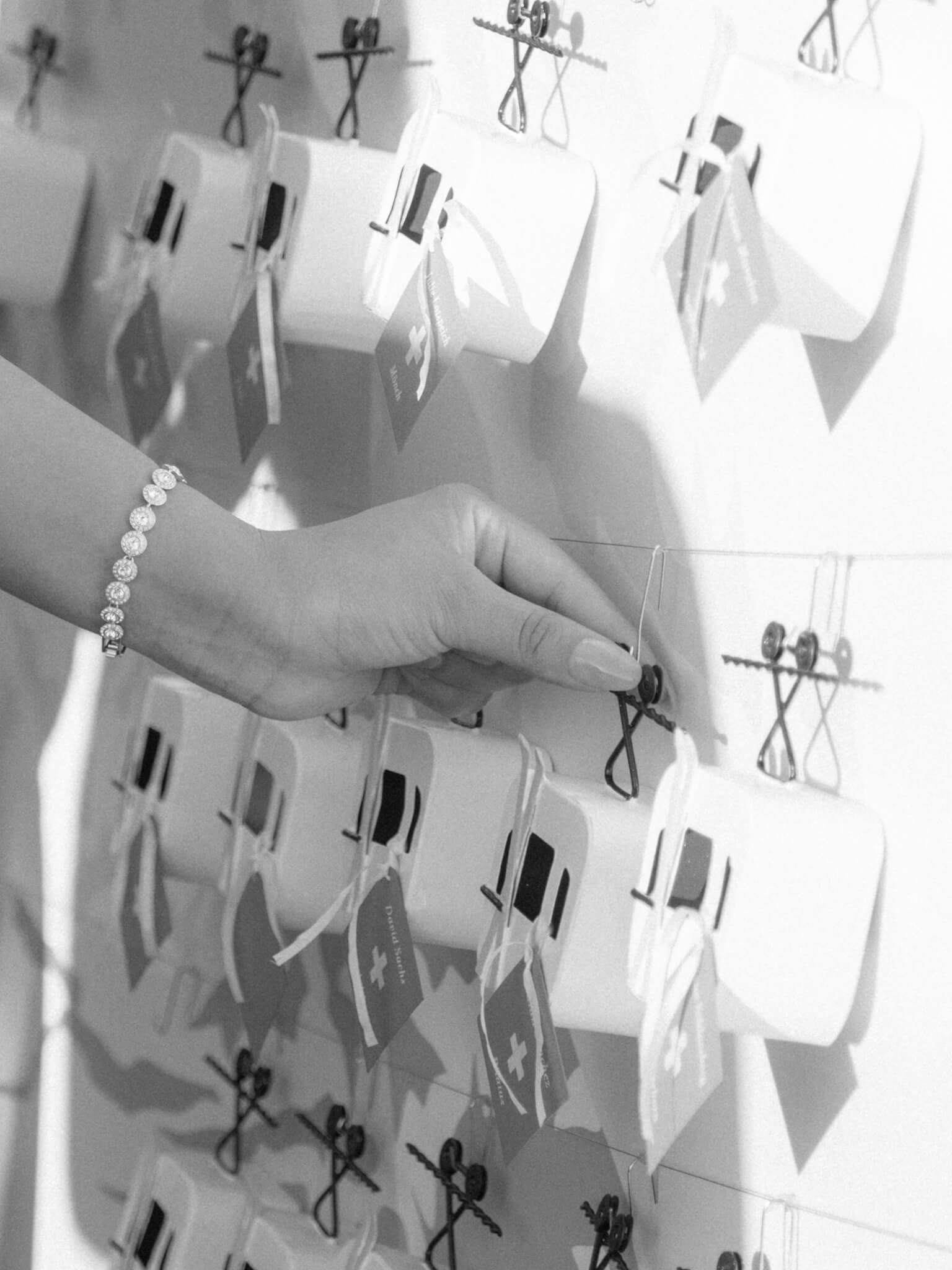 Black and white image of a woman's hand touching a gondola on an escort display.