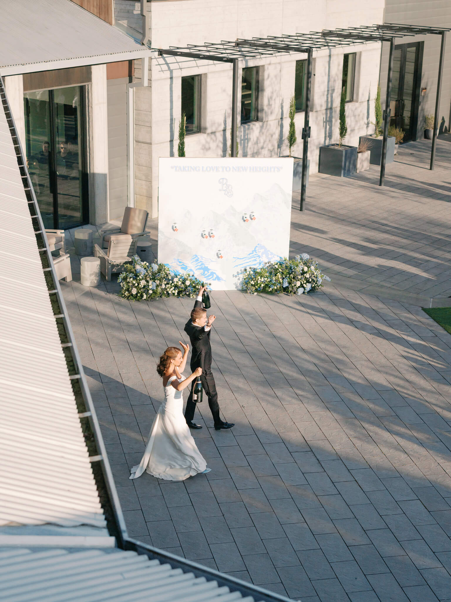 Overheard image of a bride and groom walking into their reception.